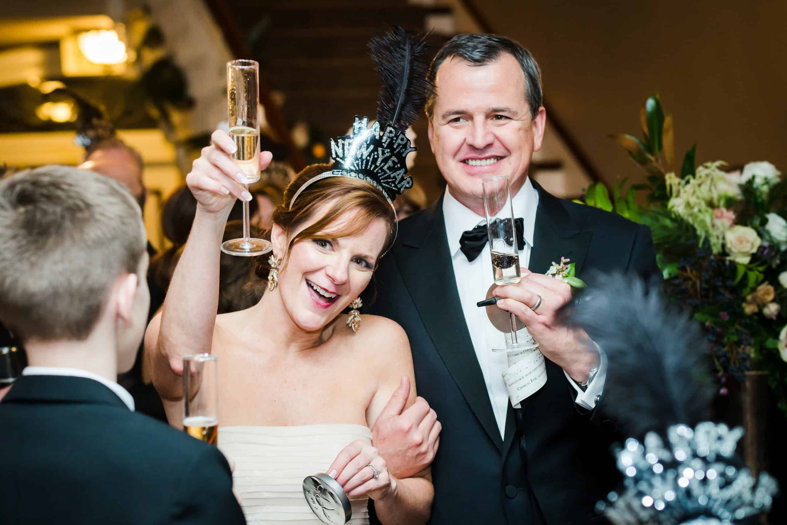 Happy bride and groom celebrating with champagne at wedding reception.