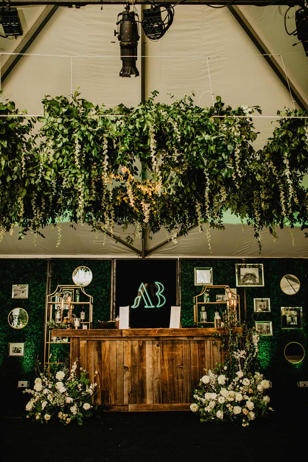 Elegant wedding reception setup with lush greenery and floral arrangements.