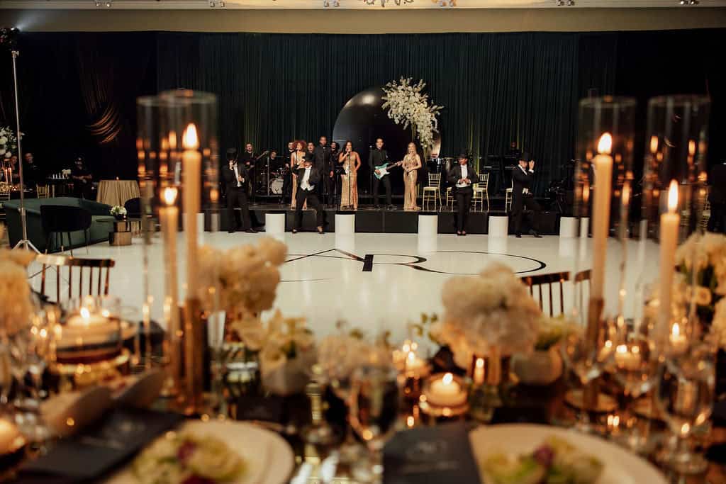 Wedding reception with live band, floral decor, and candlelit tables in Palm Beach.