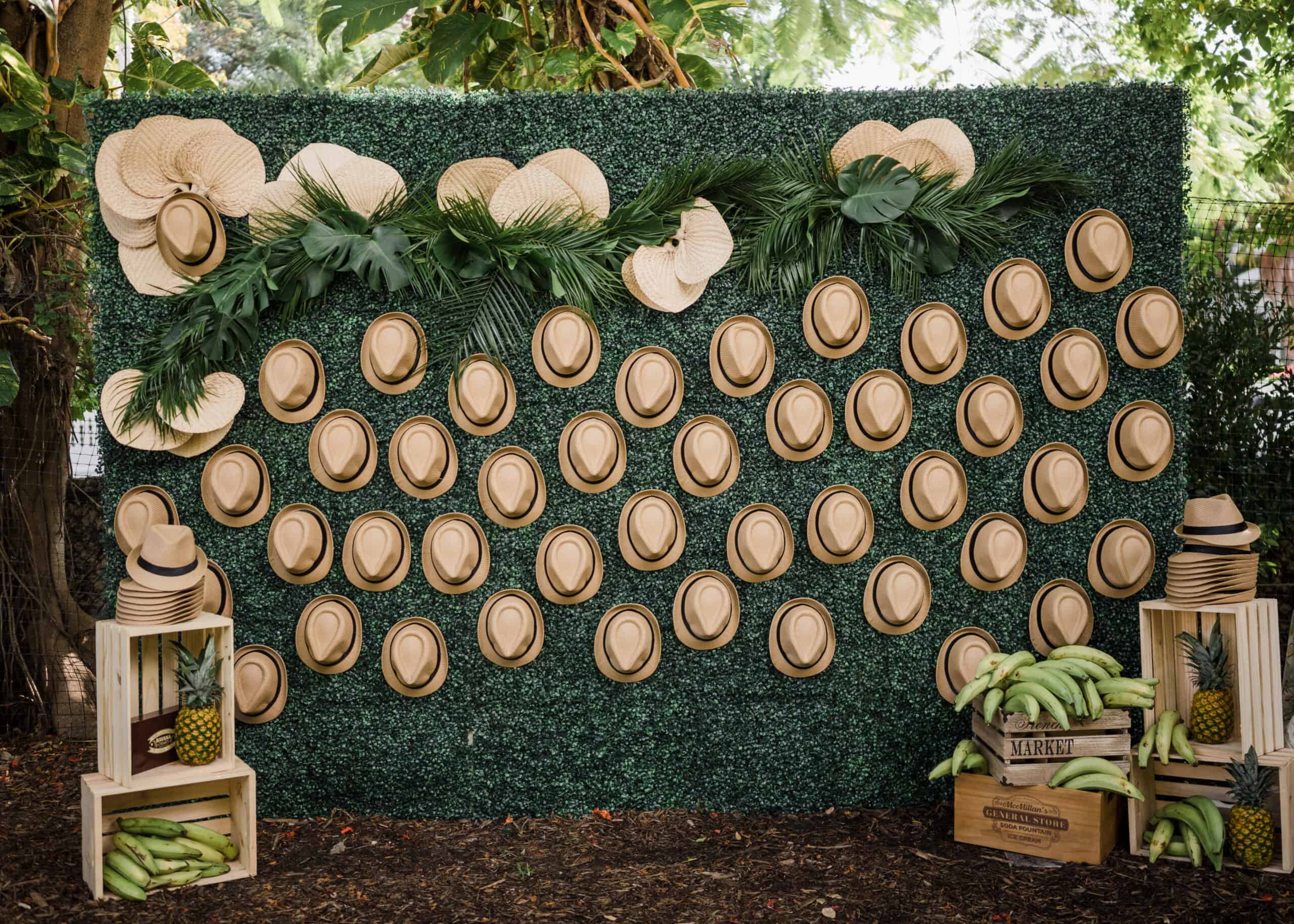 Decorative wall with hats for event photo backdrop.