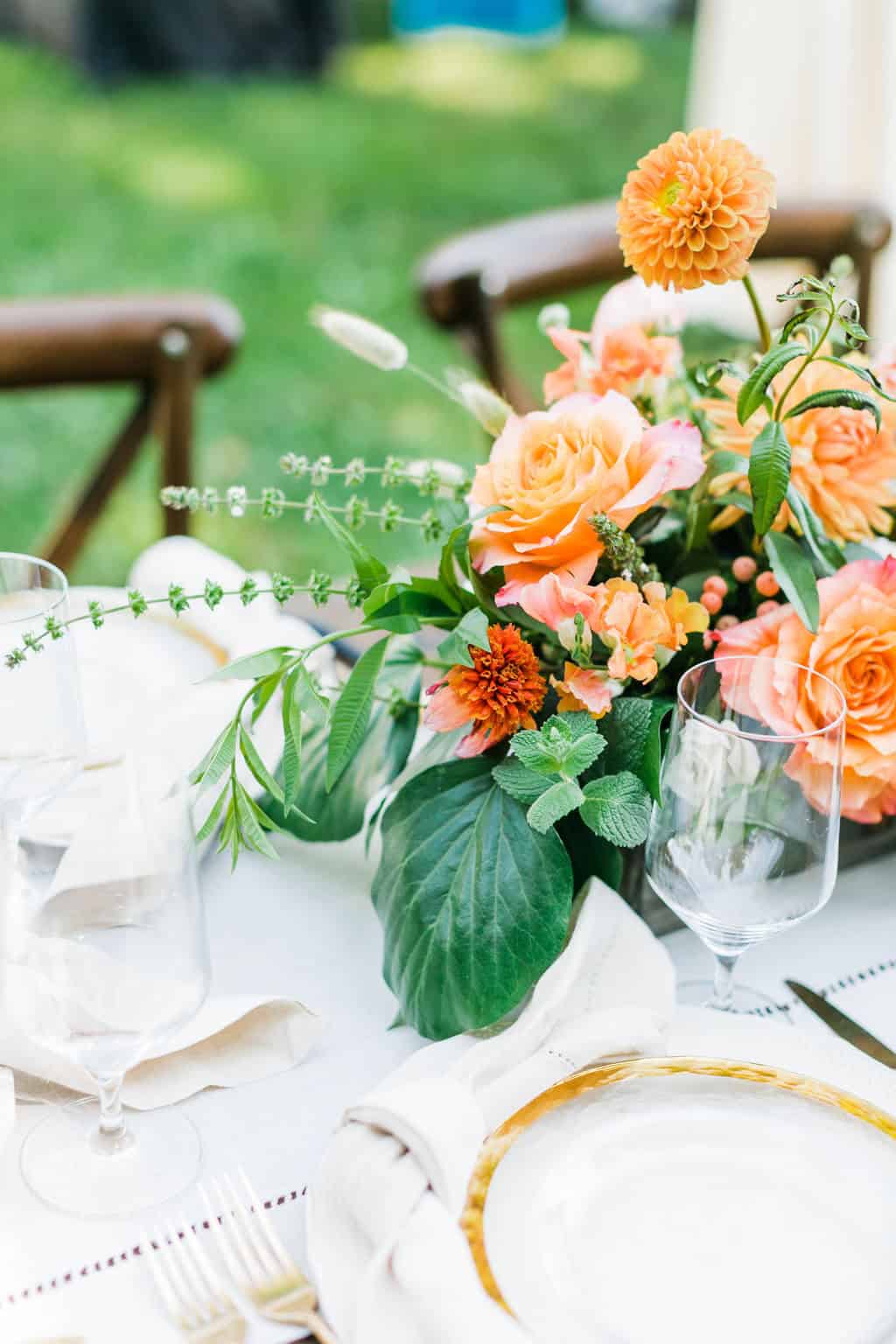 Beautiful floral centerpiece with peach and orange flowers for wedding decor.